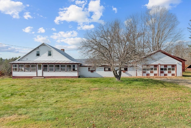 237 River Rd, Avon, ME 04966 - back of property with a sunroom, a lawn, a chimney, and metal roof