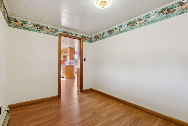 237 River Rd, Avon, ME 04966 - spare room featuring light wood-type flooring, baseboards, and a baseboard heating unit