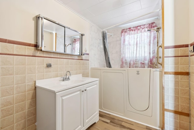 237 River Rd, Avon, ME 04966 - bathroom with tile walls, curtained shower, vanity, wood finished floors, and crown molding