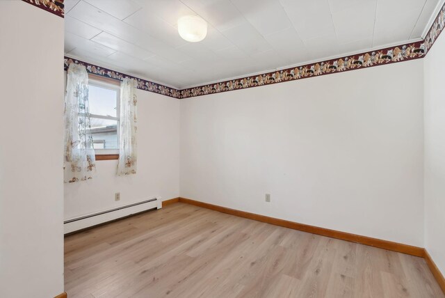 237 River Rd, Avon, ME 04966 - spare room featuring a baseboard heating unit, light wood-type flooring, and baseboards