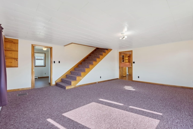 237 River Rd, Avon, ME 04966 - unfurnished living room with stairs, baseboards, carpet floors, and baseboard heating