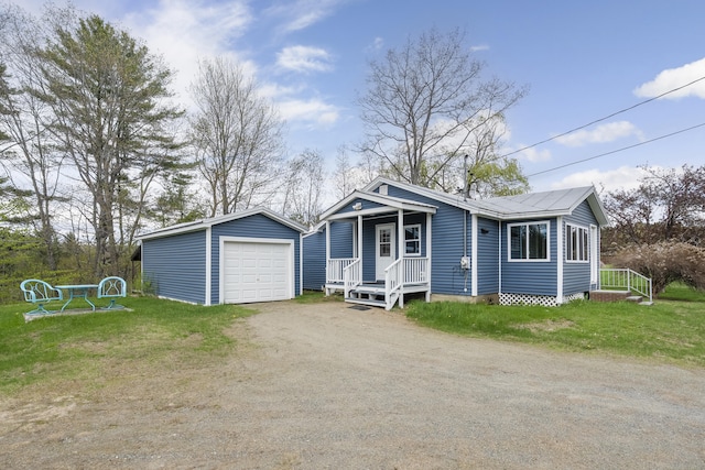 237 River Rd, Avon, ME 04966 - view of front of house featuring a garage, an outdoor structure, and driveway