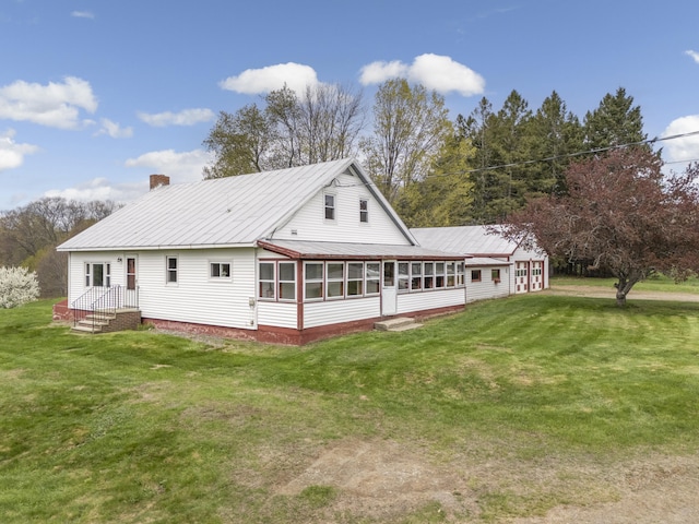 237 River Rd, Avon, ME 04966 - rear view of house featuring a sunroom, a chimney, a yard, and metal roof