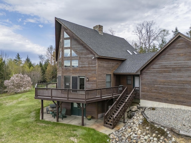 237 River Rd, Avon, ME 04966 - rear view of house with a wooden deck, a shingled roof, a patio, and a lawn