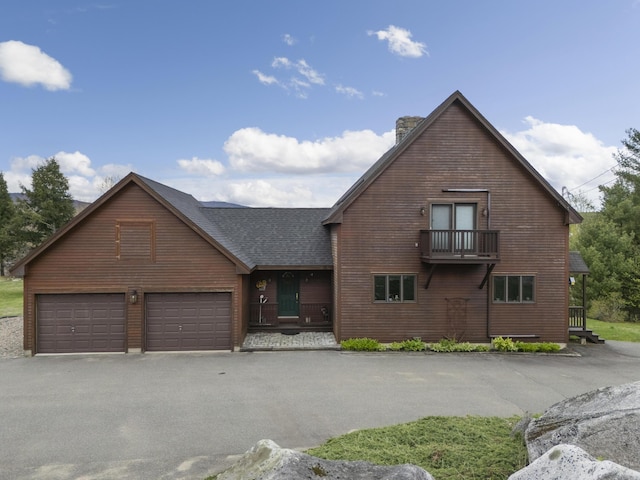 237 River Rd, Avon, ME 04966 - view of front facade featuring a chimney, a shingled roof, an attached garage, and asphalt driveway