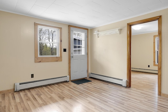 237 River Rd, Avon, ME 04966 - entryway featuring a baseboard heating unit, ornamental molding, and light wood-type flooring