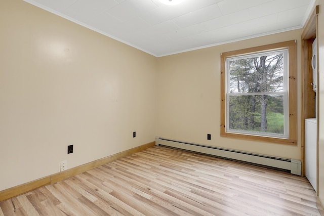 237 River Rd, Avon, ME 04966 - spare room featuring baseboard heating, ornamental molding, light wood-style flooring, and baseboards