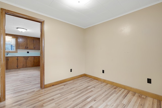 237 River Rd, Avon, ME 04966 - spare room with light wood-type flooring, baseboards, and ornamental molding
