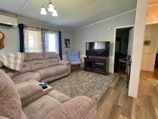 living area featuring a wall mounted AC, ornamental molding, a chandelier, vaulted ceiling, and wood finished floors