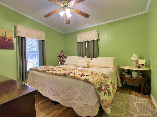 bedroom featuring wood finished floors, ornamental molding, a ceiling fan, and baseboards