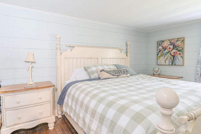 bedroom with dark wood-style flooring and crown molding