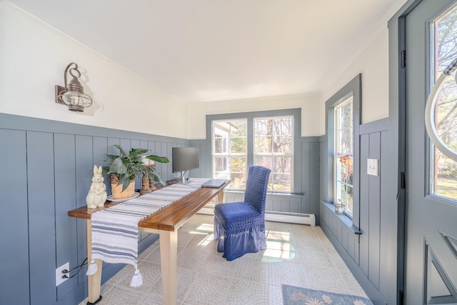 office space featuring a decorative wall, baseboard heating, plenty of natural light, a wainscoted wall, and ornamental molding