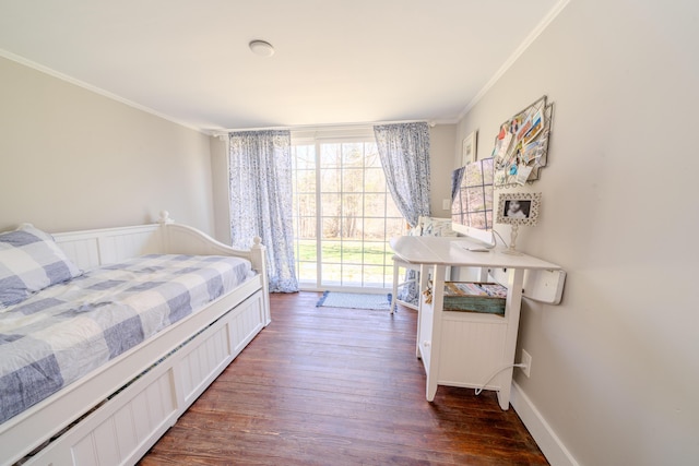 bedroom featuring crown molding and dark wood-style flooring