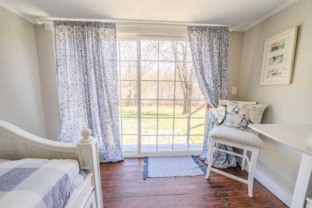 bedroom with wood finished floors and crown molding
