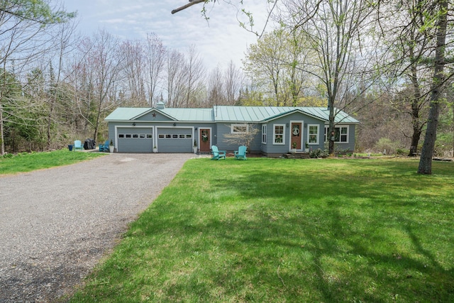 single story home featuring a garage, gravel driveway, metal roof, and a front yard