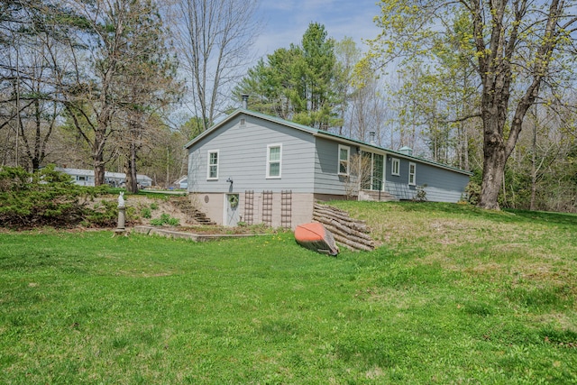 back of property with a lawn