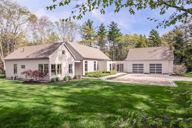 3 Bristol Ln, York, ME 03909 - back of property featuring driveway, a yard, a garage, and central AC unit