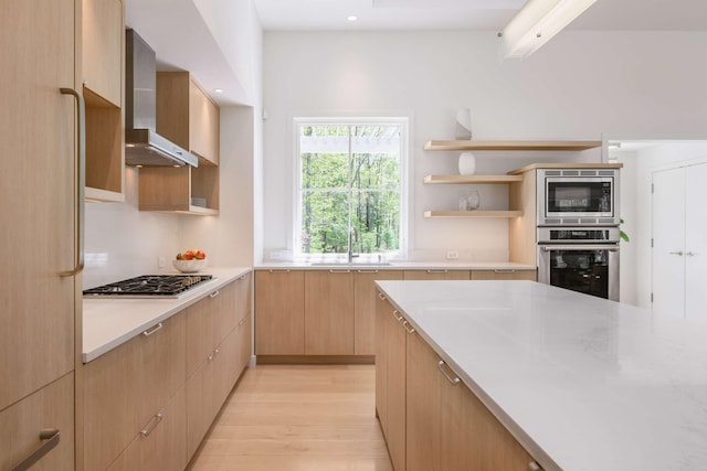 3 Bristol Ln, York, ME 03909 - kitchen featuring appliances with stainless steel finishes, light brown cabinetry, a sink, wall chimney range hood, and light countertops