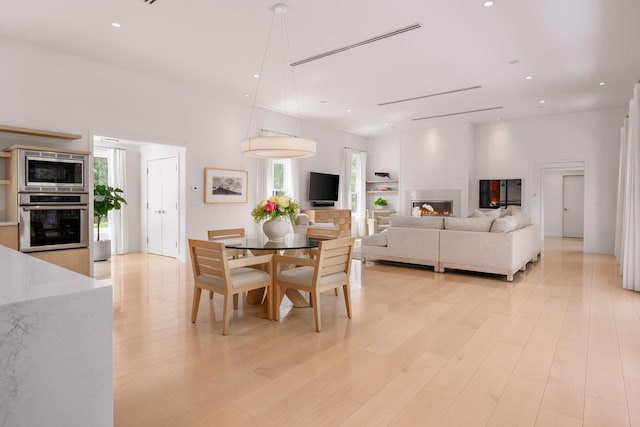 3 Bristol Ln, York, ME 03909 - dining space with healthy amount of natural light, light wood-style flooring, recessed lighting, and a glass covered fireplace