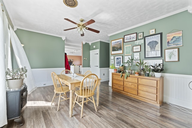 1568 Hill Rd, Canaan, ME 04924 - dining area with wainscoting, a ceiling fan, ornamental molding, and wood finished floors