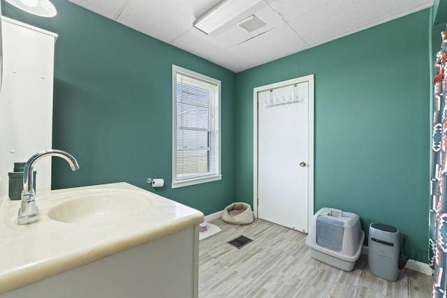 1568 Hill Rd, Canaan, ME 04924 - bathroom with a drop ceiling, baseboards, wood finished floors, and vanity