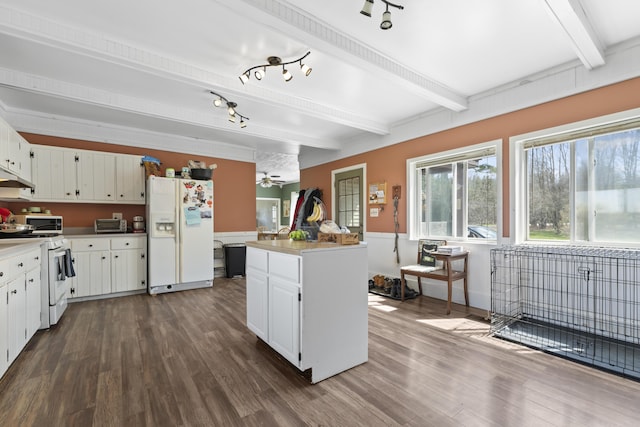 1568 Hill Rd, Canaan, ME 04924 - kitchen with white appliances, beamed ceiling, dark wood-type flooring, white cabinets, and a center island