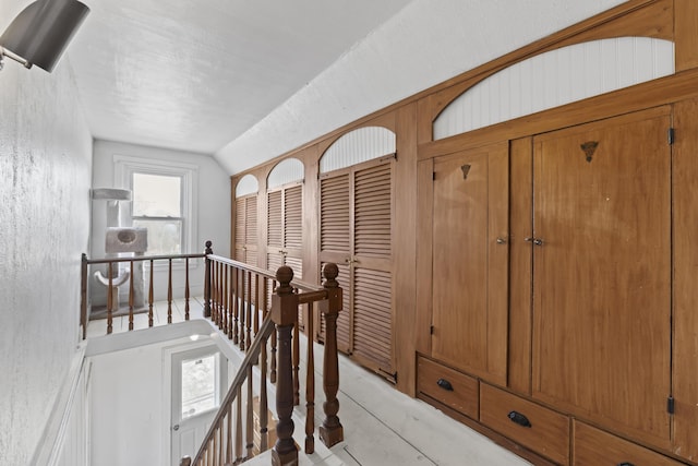 1568 Hill Rd, Canaan, ME 04924 - hallway featuring an upstairs landing, lofted ceiling, and a textured wall