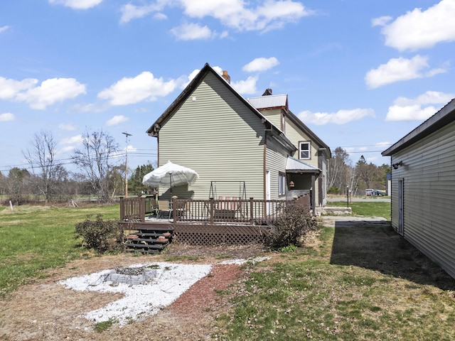 1568 Hill Rd, Canaan, ME 04924 - view of home's exterior with a wooden deck, a chimney, and a lawn
