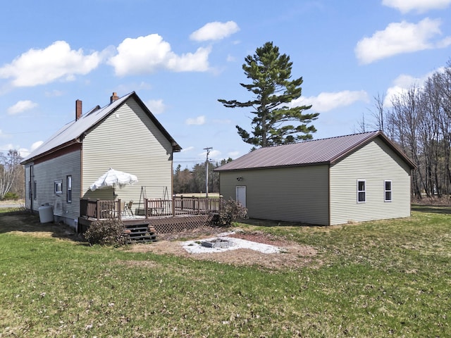 1568 Hill Rd, Canaan, ME 04924 - back of house with a wooden deck, a lawn, and metal roof