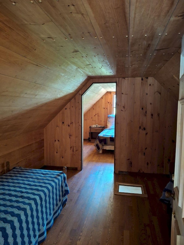 27 Kingman Beach Rd, Osborn, ME 04605 - bedroom with wood walls, wooden ceiling, lofted ceiling, and wood-type flooring