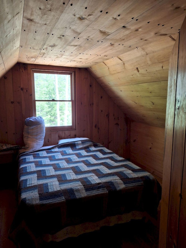 27 Kingman Beach Rd, Osborn, ME 04605 - bedroom featuring vaulted ceiling and wood walls
