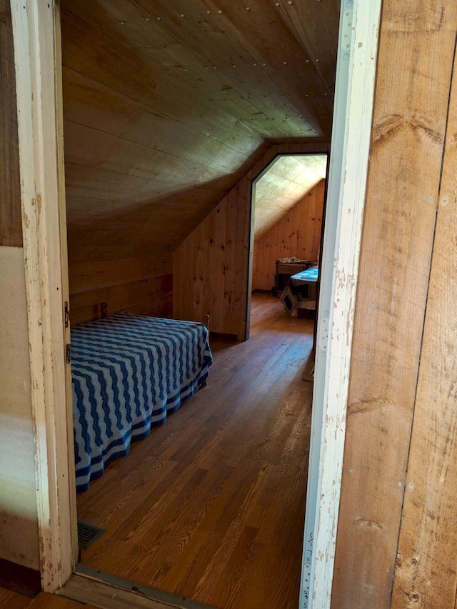 27 Kingman Beach Rd, Osborn, ME 04605 - bedroom featuring vaulted ceiling, wood finished floors, wooden ceiling, and wooden walls