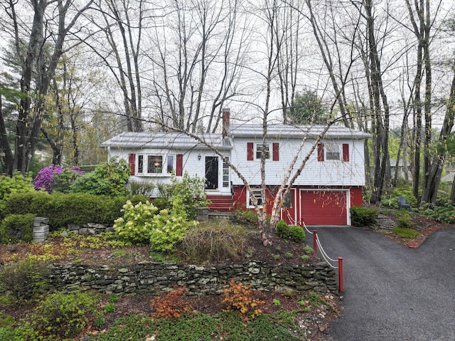 11 Moreau Ave, Lewiston, ME 04240 - tri-level home with an attached garage, driveway, and a chimney