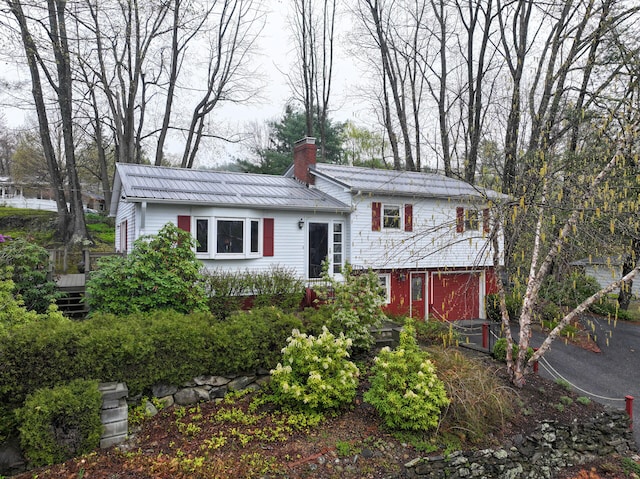 11 Moreau Ave, Lewiston, ME 04240 - split level home with a chimney and metal roof