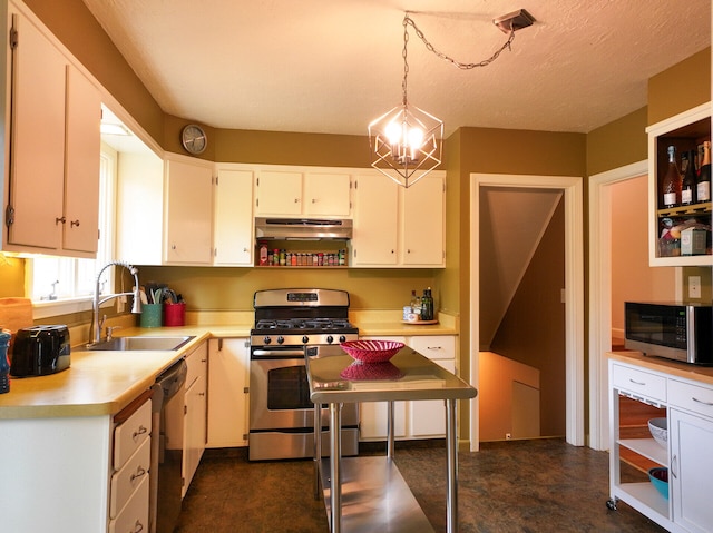 11 Moreau Ave, Lewiston, ME 04240 - kitchen featuring stainless steel appliances, a sink, under cabinet range hood, light countertops, and a chandelier