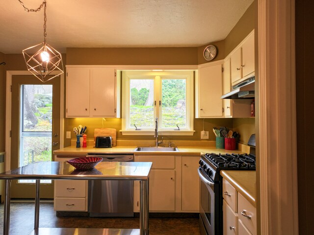 11 Moreau Ave, Lewiston, ME 04240 - kitchen featuring appliances with stainless steel finishes, a sink, under cabinet range hood, light countertops, and pendant lighting