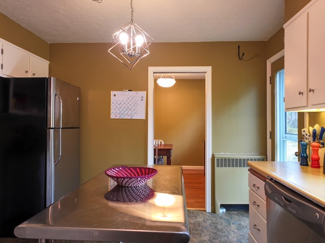 11 Moreau Ave, Lewiston, ME 04240 - kitchen featuring stainless steel appliances, white cabinetry, a chandelier, hanging light fixtures, and a kitchen island