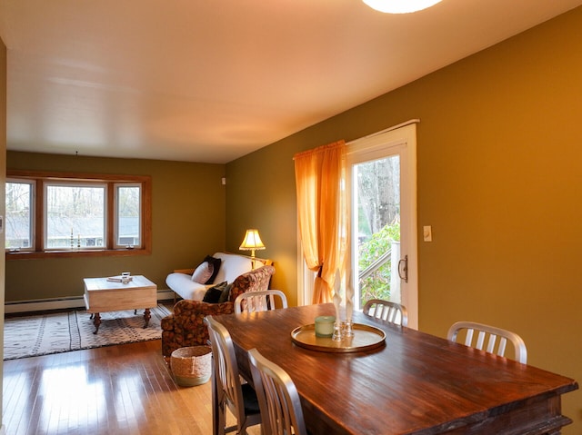 11 Moreau Ave, Lewiston, ME 04240 - dining space featuring a baseboard radiator, healthy amount of natural light, hardwood / wood-style flooring, and baseboard heating