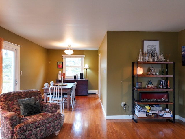 11 Moreau Ave, Lewiston, ME 04240 - dining area with wood finished floors, a baseboard heating unit, and baseboards