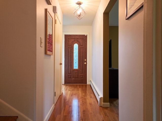 11 Moreau Ave, Lewiston, ME 04240 - doorway to outside featuring a baseboard heating unit, hardwood / wood-style floors, and baseboards