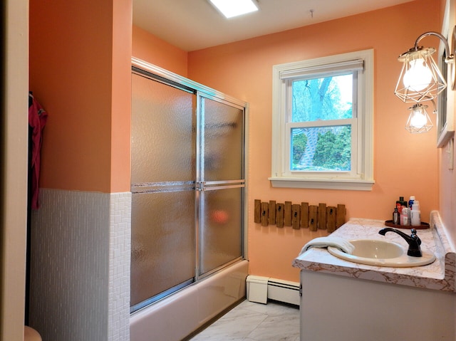 11 Moreau Ave, Lewiston, ME 04240 - full bathroom with baseboard heating, marble look tile flooring, bath / shower combo with glass door, and vanity