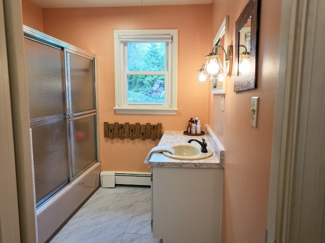 11 Moreau Ave, Lewiston, ME 04240 - full bath featuring a baseboard heating unit, marble look tile flooring, vanity, and enclosed tub / shower combo