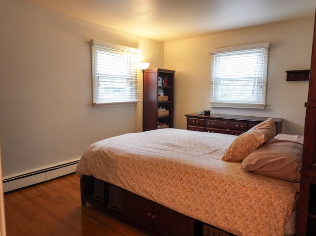 11 Moreau Ave, Lewiston, ME 04240 - bedroom featuring a baseboard heating unit, wood finished floors, and multiple windows