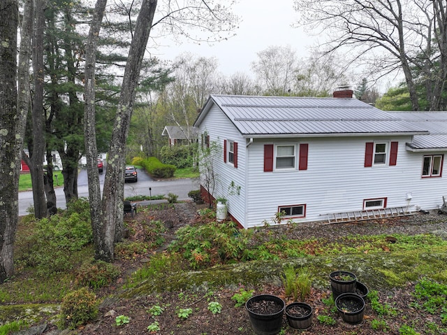11 Moreau Ave, Lewiston, ME 04240 - view of side of property with a chimney and metal roof