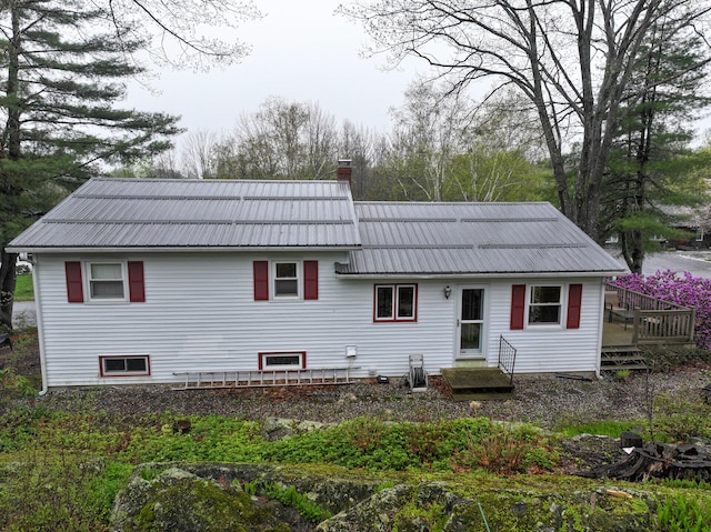 11 Moreau Ave, Lewiston, ME 04240 - back of property with a chimney, metal roof, and a deck