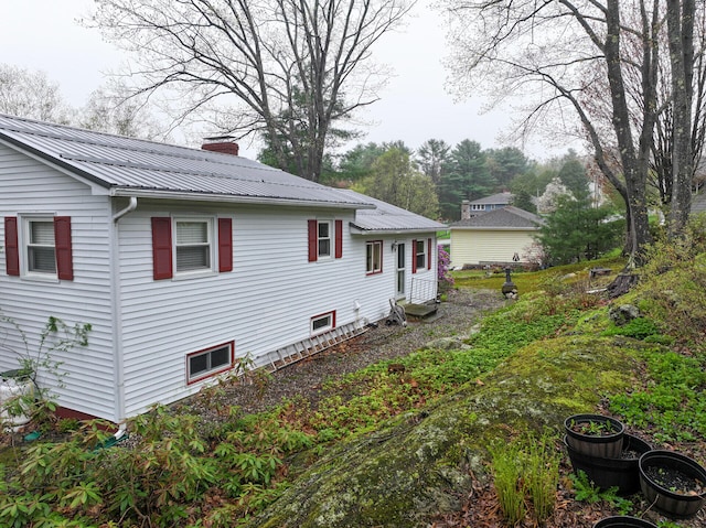 11 Moreau Ave, Lewiston, ME 04240 - view of side of property with a chimney, metal roof, and entry steps