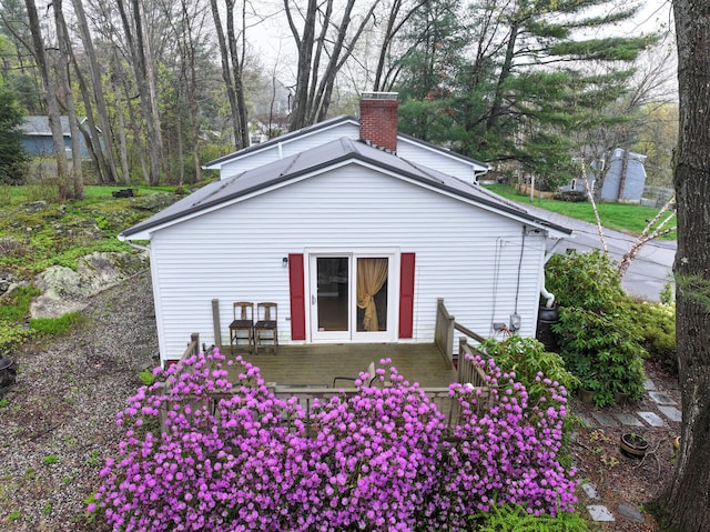 11 Moreau Ave, Lewiston, ME 04240 - back of property with a deck and a chimney