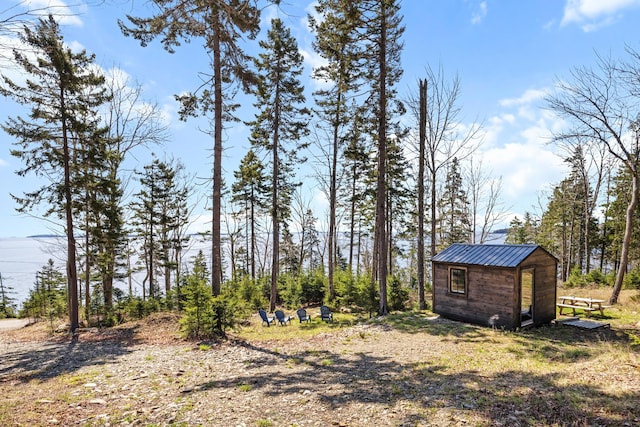 197 E Shore Dr, Islesboro, ME 04848 - view of yard featuring an outdoor structure and a storage unit