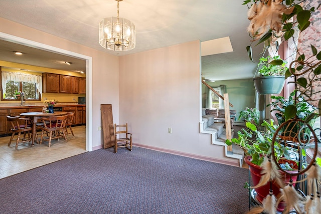 dining area with a chandelier, stairway, light colored carpet, and baseboards