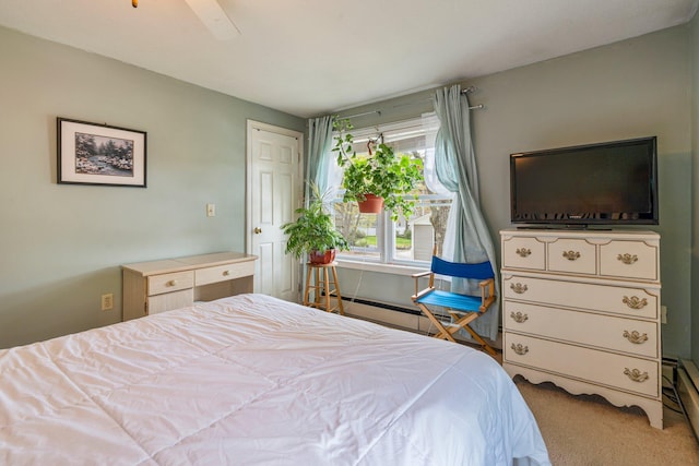 carpeted bedroom with baseboard heating and a ceiling fan